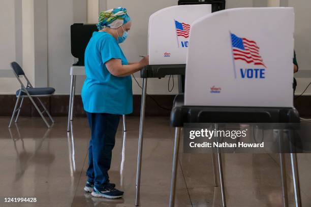 Voter casts their ballot at a polling place at the Baltimore War Memorial Building during the midterm primary election on July 19, 2022 in Baltimore,...