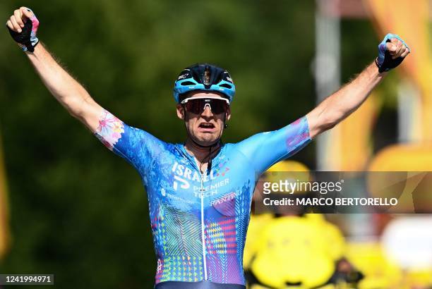 Israel-Premier Tech team's Canadian rider Hugo Houle celebrates as he cycles to the finish line to win the 16th stage of the 109th edition of the...