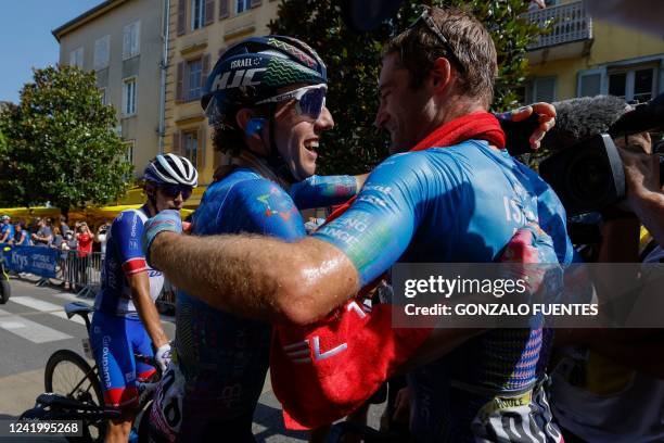 Israel-Premier Tech team's Canadian rider Hugo Houle is congratulated by Israel-Premier Tech team's Canadian rider Michael Woods after winning the...