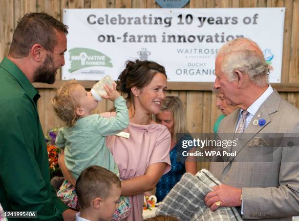 Prince Charles, Prince of Wales is given a gift by Dusty and George Smith, sons of Matt and Pip Smith, as he attends the Innovative Farmers 10th...