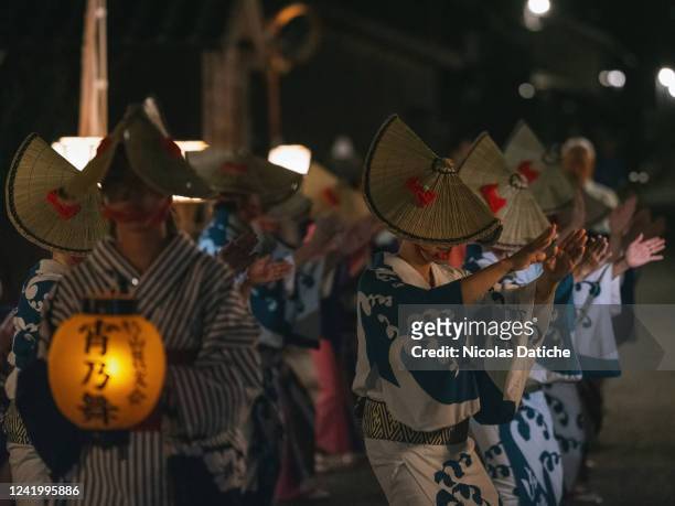 Dancers dance in a old street during a "Sado World Heritage Cultural Heritage Registration Prayer - Night Gozen Odori" a small version of a kind of...