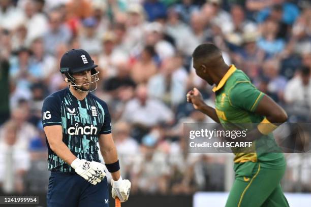 South Africa's Lungi Ngidi celebrates taking the wicket of England's Liam Livingstone , who reacts while leaving the pitch during the first One Day...