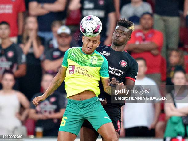 Midtjylland's Guinean forward Sory Kaba and AEK Larnaca's Venezuelan midfielder Roberto Rosales vie for the ball during the Champions League...
