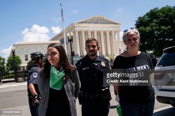 Rep. Alexandria Ocasio-Cortez is detained after outside the Supreme Court of the United States during a sit-in protesting the high court overturning...