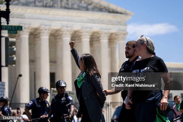 Rep. Alexandria Ocasio-Cortez is detained after outside the Supreme Court of the United States during a sit-in protesting the high court overturning...