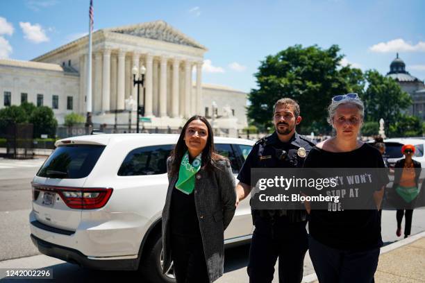 Representative Alexandria Ocasio-Cortez, a Democrat from New York, left, is arrested outside the US Supreme Court during a protest of the court...