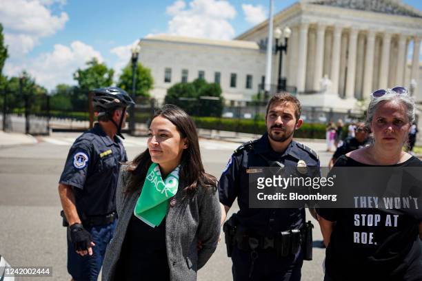 Representative Alexandria Ocasio-Cortez, a Democrat from New York, left, is arrested outside the US Supreme Court during a protest of the court...