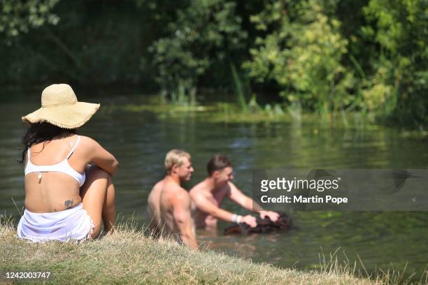 Visitors ignore warnings to stay at home and enjoy their time swimming and sunbathing at Granchester Meadows on July 19, 2022 in Cambridge, United...