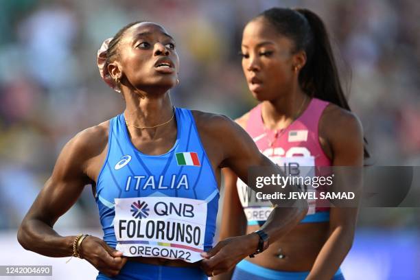 S Britton Wilson and Italy's Ayomide Temilade Folorunso look on after coming in first and second in a heat of the women's 400m hurdles during the...