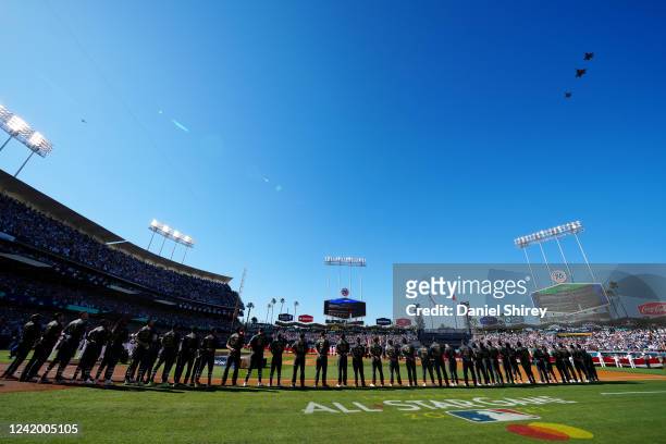 Military flyover takes place during the singing of the national anthem prior to the 92nd MLB All-Star Game presented by Mastercard at Dodger Stadium...