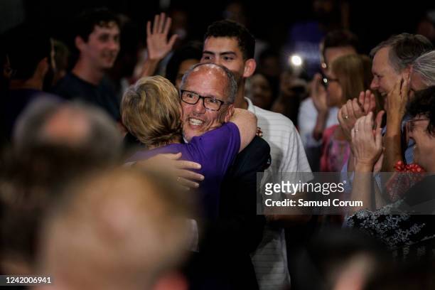 Tom Perez hugs a supporter as he arrives with Shannon Sneed for a primary election night event at Tommy Joe's on July 19, 2022 in Bethesda, Maryland....