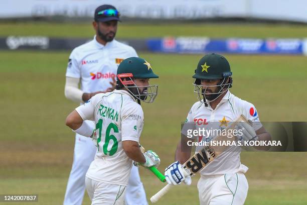 Pakistans Abdullah Shafique and Mohammad Rizwan run between wickets during the final day of play of the first cricket Test match between Sri Lanka...