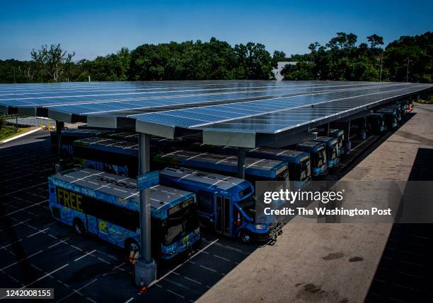 Solar panels make up the roof over parked busses as Montgomery County nears completion of construction on its micro-grid enabled electric bus...