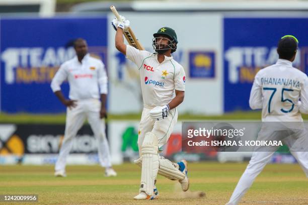 Pakistans Abdullah Shafique celebrates after Pakistan won by 4 wickets at the end of the final day of play of the first cricket Test match between...