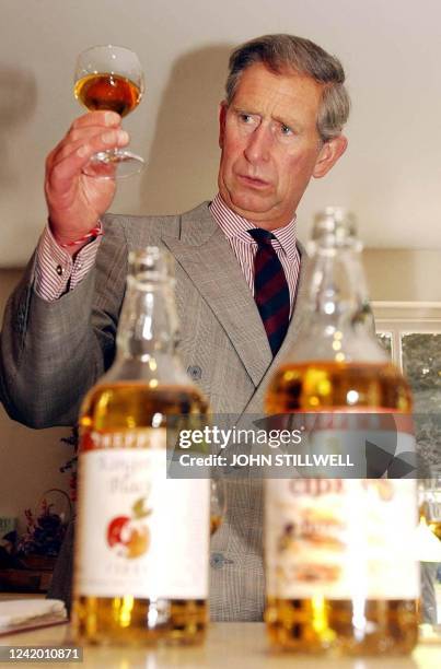 The Prince of Wales takes a tentative look before tasting a glass of Cider at Sheppy's Cider Farm Centre, outside Taunton Somerset, 04 July 2003. He...