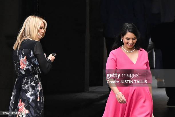 Britain's Home Secretary Priti Patel walks past member of Parliament Esther McVey as she leaves the Houses of Parliament at the end of the last...