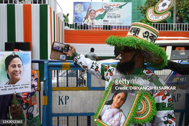 An activist of the All India Trinamool Congress party, wears a picture of West Bengal's state chief minister Mamata Banerjee on the eve of the annual...