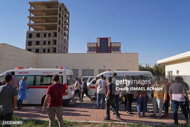 People gather outside a hospital following Turkish shelling in the city of Zakho in the north of Iraq's autonomous Kurdish region on July 20, 2022. -...