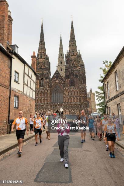 Angela Burns takes part in The Queen's Baton Relay as it visits Lichfield as part of the Birmingham 2022 Queens Baton Relay on July 20 2022 in...