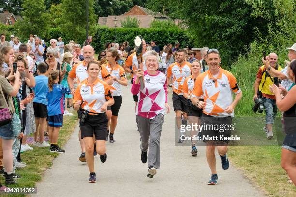 Jane Cooke takes part in The Queen's Baton Relay as it visits Lichfield as part of the Birmingham 2022 Queens Baton Relay on July 20 2022 in...