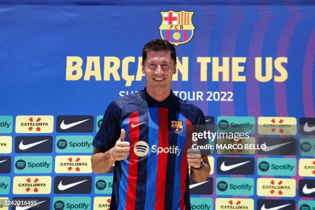 Polish football player Robert Lewandowski, gives thumbs up during a press conference in Fort Lauderdale, Florida, on July 20 as he is introduced as...