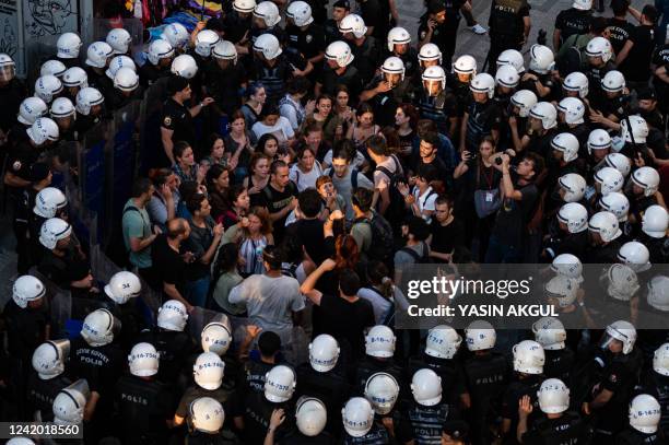 Police officers surround protesters during a rally, in Kadikoy district, in Istanbul, on July 20, 2022. - Called to mark on the anniversary of the...