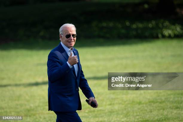 President Joe Biden gestures toward reporters as he departs Marine One and walks to the Oval Office on the South Lawn of the White House July 20,...