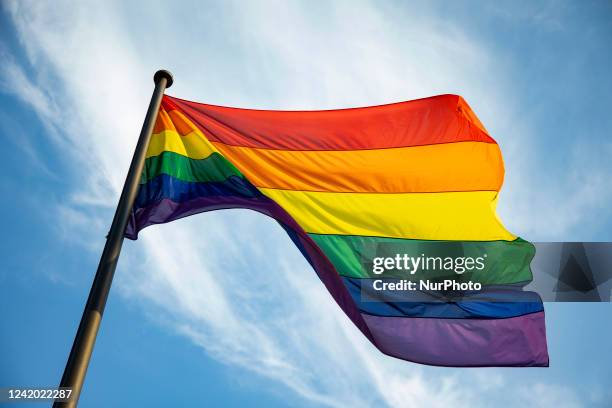 Rainbow flag flyes on the background of a blue sky in Berlin, Germany on July 20, 2022.