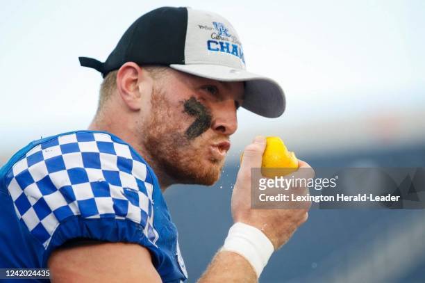 Kentucky quarterback Will Levis takes a bite out of an orange after the Wildcats defeated Iowa 20-17 in the VRBO Citrus Bowl in Orlando, Florida, on...