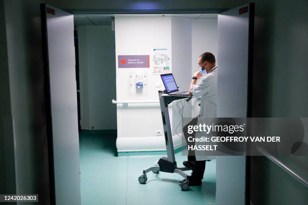 Doctor Mhirsi works on a computer inside the emergency department of the Quatres villes hospital in Saint-Cloud, west of Paris, on July 20, 2022. In...