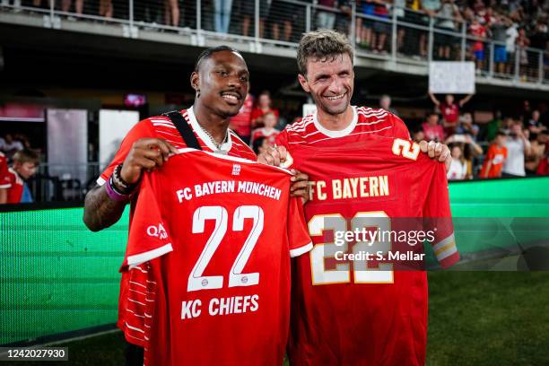 Thomas Mueller of FC Bayern Muenchen and Mecole Hardman of the Kansas City Chiefs pose after the pre-season friendly match between DC United and...