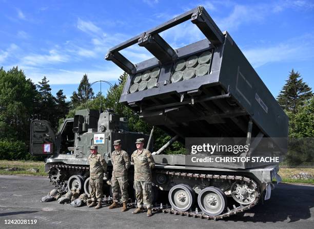 Soldiers the British Army's 1st Royal Horse Artillery stand in front of an armored, self-propelled, Multiple Launch Rocket System during the 'Dynamic...