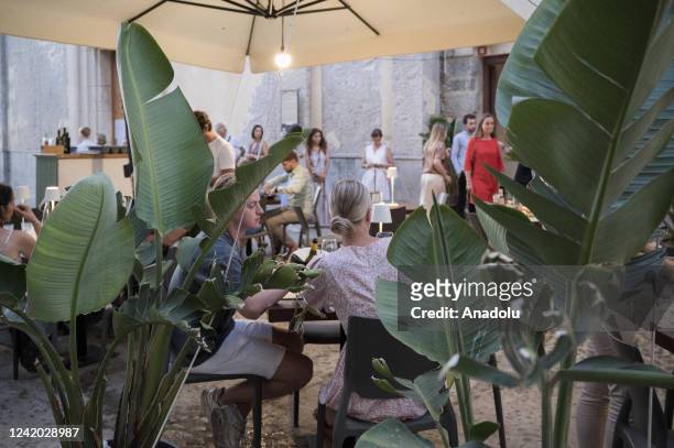 Local restaurants with tables on the coastline are seen during summer season as local and foreigner tourists start to gather in Cefalu, the old town...