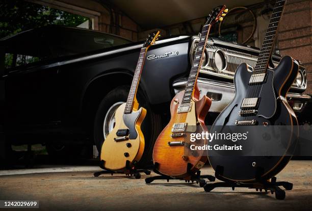 Trio of Gibson Murphy Lab Series electric guitars photographed alongside a vintage Dodge Coronet 440, including a 57 Les Paul Junior Single Cut...