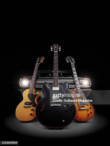 Trio of Gibson Murphy Lab Series electric guitars photographed alongside a vintage Dodge Coronet 440, including a 57 Les Paul Junior Single Cut...