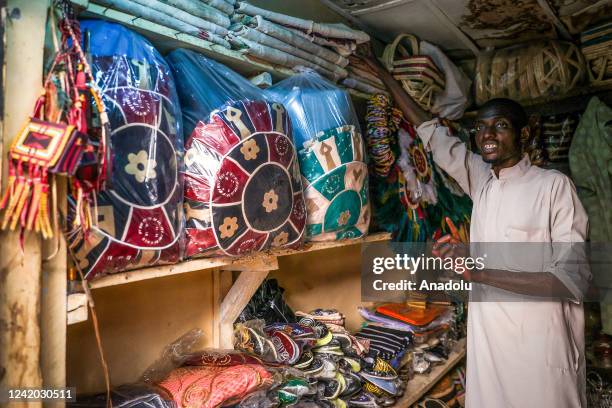 Man is seen at his own leather shop in Kano, Nigeria on July 11, 2022. The province of Kano ensures that local fabrics reach various using ancient...