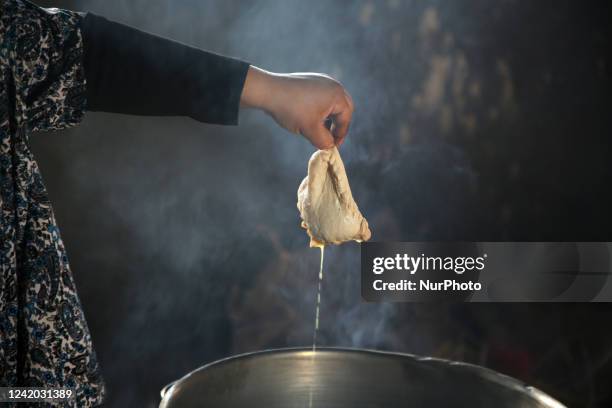 Palestinian mother prepares a cow tripe at her house in Beit Lahia in the northern Gaza Strip, on July 21, 2022.