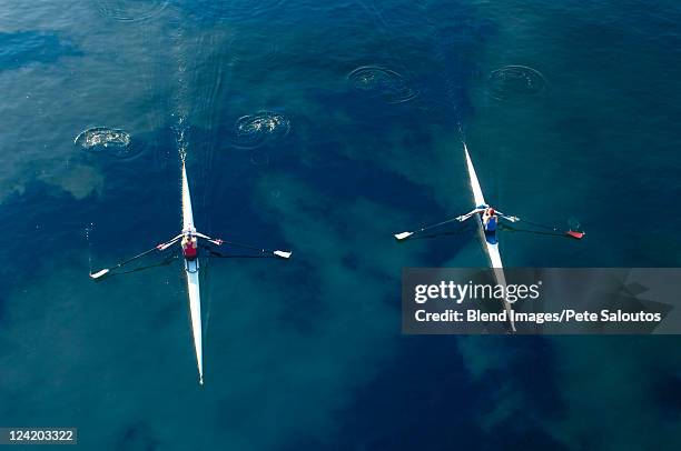 people rowing sculling boats on river - rowing overhead stock pictures, royalty-free photos & images