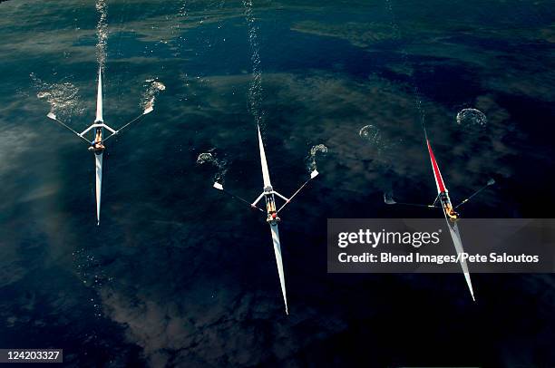 people rowing sculling boats on river - rowing overhead stock pictures, royalty-free photos & images