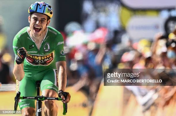 Jumbo-Visma team's Belgian rider Wout Van Aert wearing the sprinter's green jersey celebrates as he cycles to the finish line the 18th stage of the...