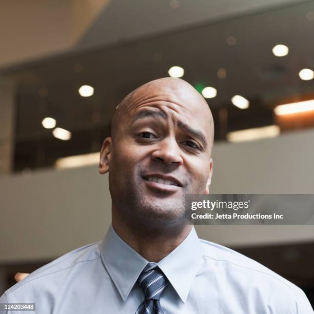 skeptical mixed race businessman - eyebrow stock pictures, royalty-free photos & images