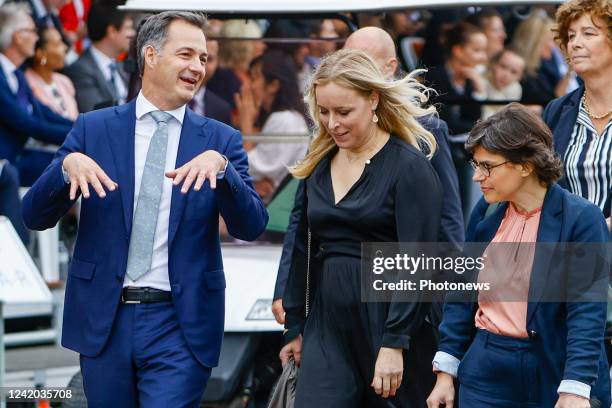 Alexander De Croo, Prime Minister of Belgium talking to ministers Eva De Bleeker and Tinne Van Der Straeten pictured during the military parade for...