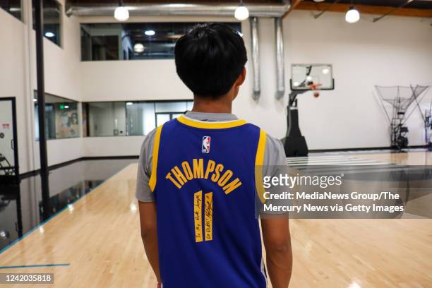 Joseph Tagaban wears a Golden State Warriors' Klay Thompson signed jersey at a gym in San Clemente, Calif., on July 15, 2022. The Warriors star will...