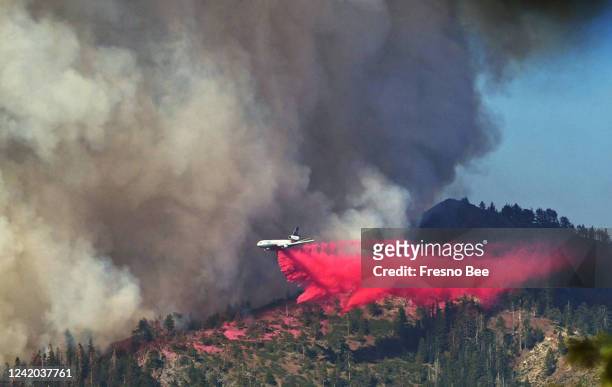 Plane drops fire retardant as the Washburn Fire as it burns near the Mariposa Grove of giant sequoias and the south entrance of Yosemite National...