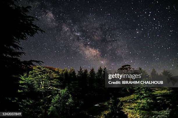 This long-exposure picture taken early on July 21 shows a view of the Milky Way galaxy in the sky above the cedar forest reserve, also known as the...