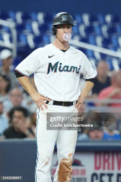 Miami Marlins third baseman Joey Wendle works on blowing bubbles at third base during the game between the Texas Rangers and the Miami Marlins on...