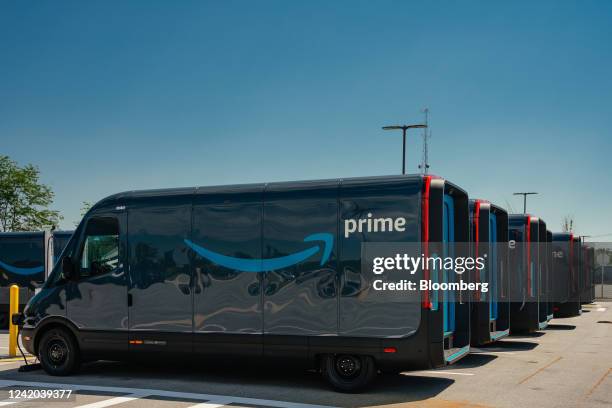 Amazon.com delivery electric vans , built by Rivian Automotive, parked outside the Amazon Logistics warehouse in Chicago, Illinois, US, on Thursday,...