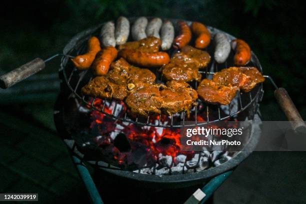 Steaks, chicken breasts and sausages being grilled over charcoal. On Thursday, July 21 in Rzeszow, Subcarpathian Voivodeship, Poland.