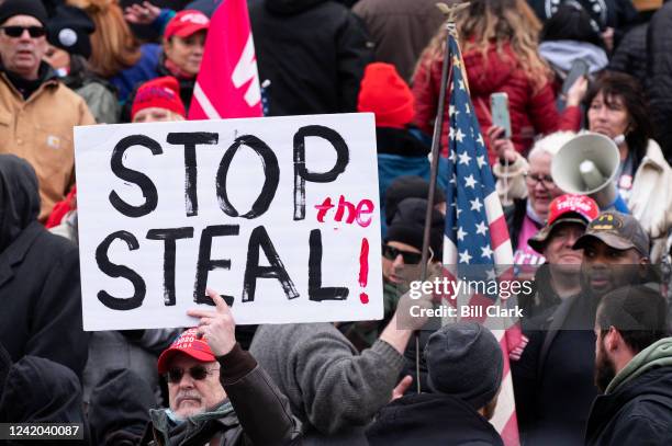 Man holds a stop the steal sign as rioters take over the steps of the Capitol on the East Front on Wednesday, Jan. 6 as the Congress works to certify...