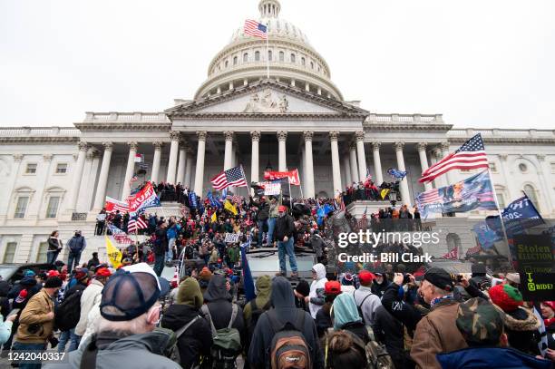 Trump flags fly as rioters take over the steps of the Capitol on the East Front on Wednesday, Jan. 6 as the Congress works to certify the electoral...